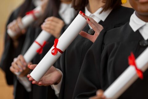 close-up-people-graduating-with-diplomas (1)