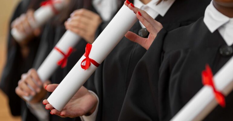 close-up-people-graduating-with-diplomas (1)